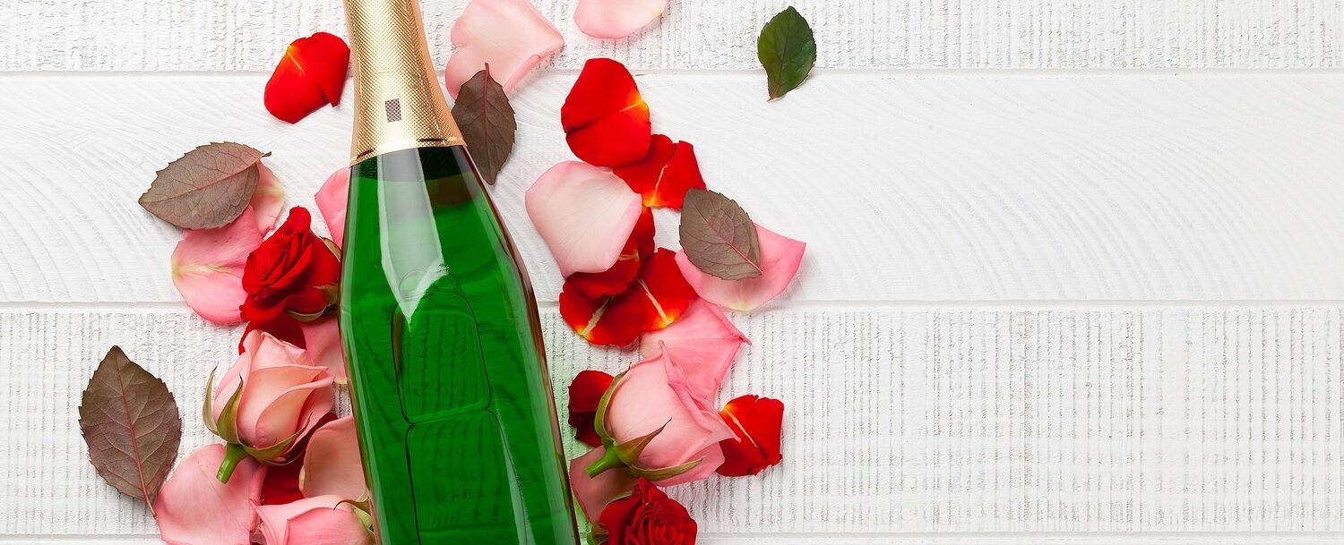 a bottle of Champagne with rose petals